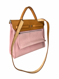 Pre-owned Hermès Herbag Zip 31 in pink canvas, rear view showing the exterior zip pocket and removable shoulder strap, authenticated by MIKUN