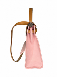 Pre-owned Hermès Herbag Zip 31 in pink canvas, side profile showing the trapezoidal silhouette and palladium Clou de Selle hardware, authenticated by MIKUN