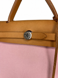 Pre-owned Hermès Herbag Zip 31, close detail of the palladium Clou de Selle closure stamped HERMES PARIS against natural Vache Hunter leather, authenticated by MIKUN